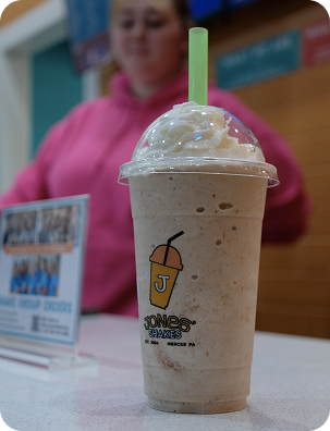 Customer holding a blended coffee milkshake